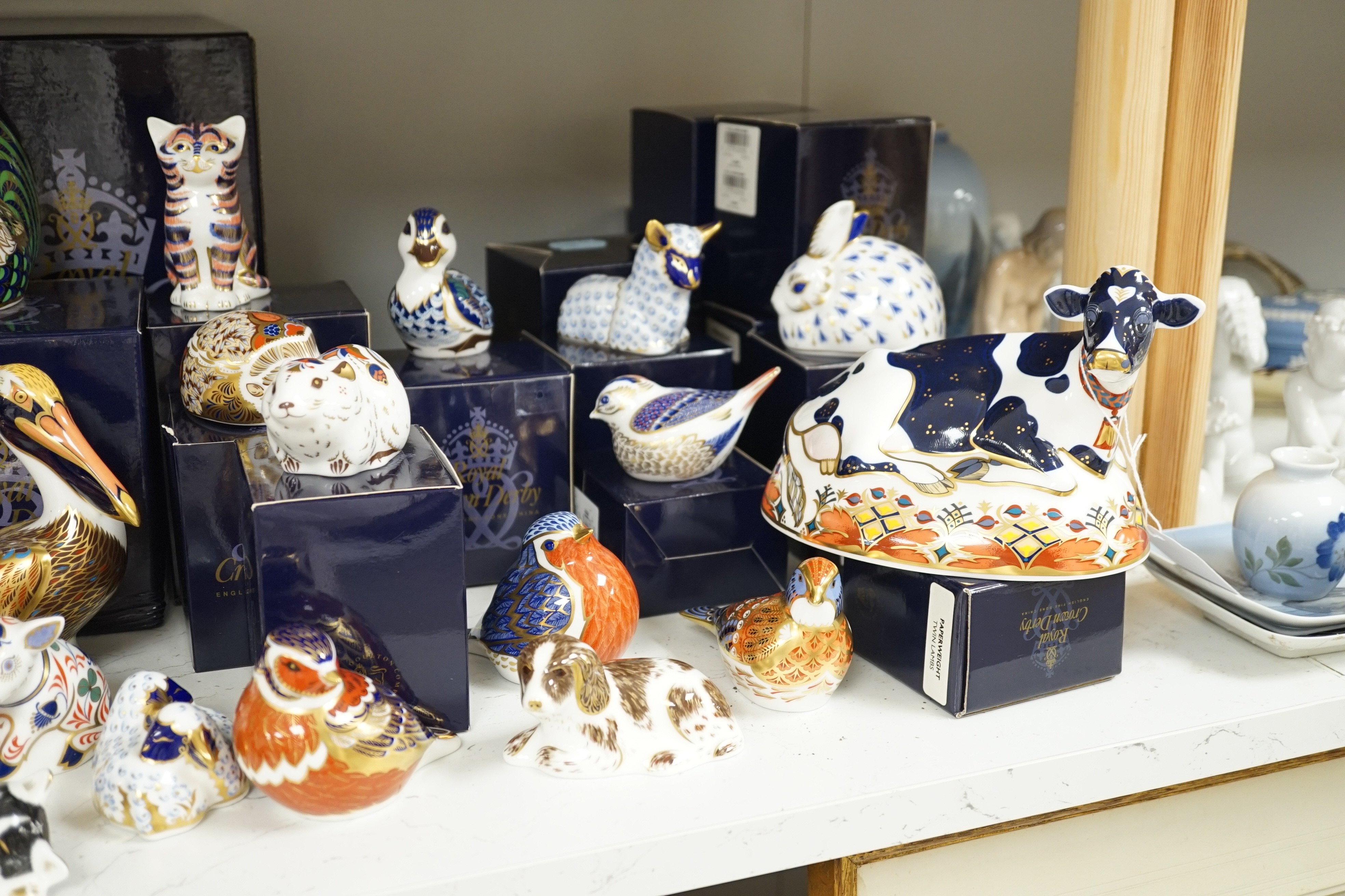 Approximately thirty-two Royal Crown Derby Imari porcelain paperweights, all but two with original boxes and mostly gold bottoms